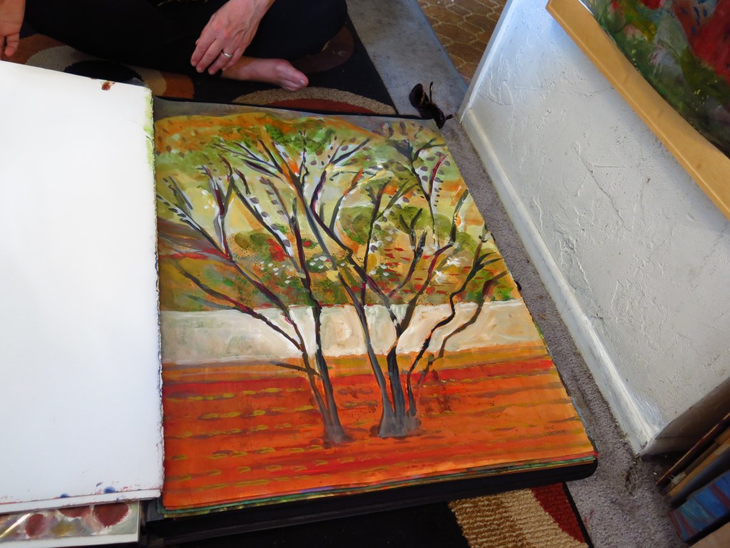 Joyce Lieberman showing a piece from her "Trees" works on paper.